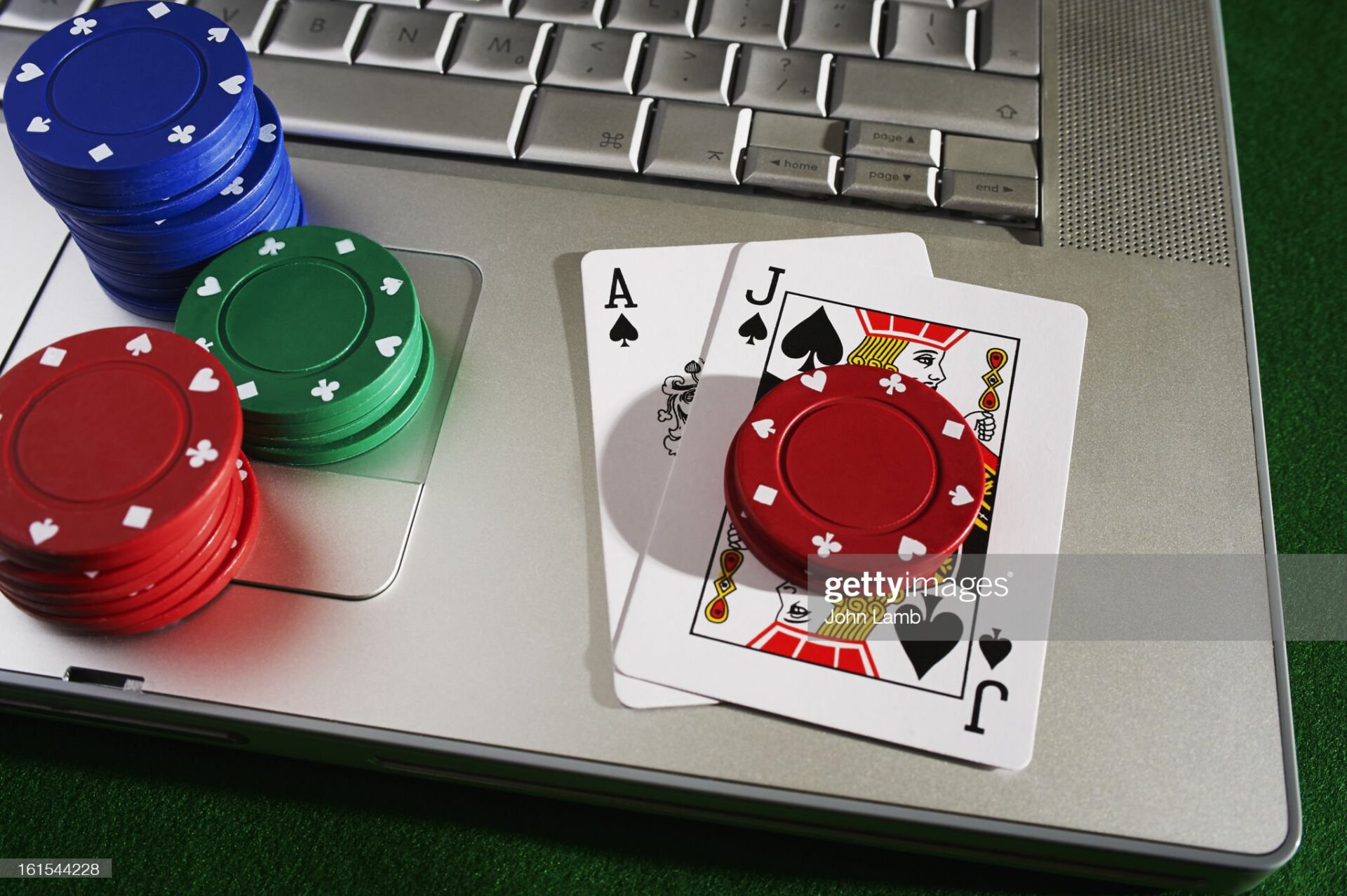 Blackjack hand with chips and laptop computer